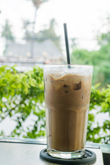 Ice coffee on a wooden table