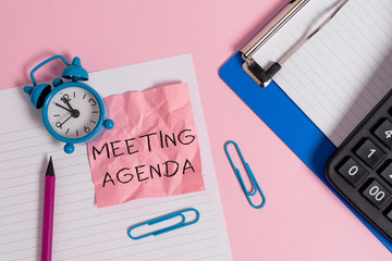 Conceptual hand writing showing Meeting Agenda. Concept meaning items that participants hope to accomplish at a meeting Paper sheet clipboard pencil calculator clock colored background