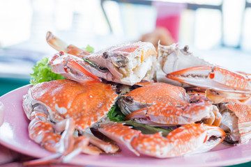 Steamed crabs on a plate on the table.