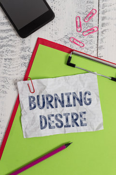 Handwriting text Burning Desire. Conceptual photo Extremely interested in something Wanted it very much Clipboard paper sheet pencil smartphone note clips wooden retro background