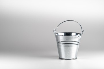 Small galvanized bucket on white background.