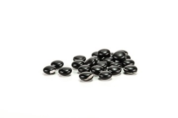 expired black pills on white background.