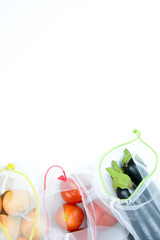Seasonal vegetables in a grocery bag on a white background. Copy space, flat lay. Zero waste concept.