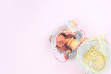 Fruit in a grocery bag on a pink background,copy space. Zero waste concept
