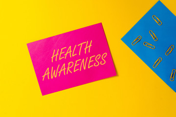 Conceptual hand writing showing Health Awareness. Concept meaning Promoting community issues and preventative action Blank paper sheets message reminder clips binders color background