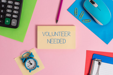 Conceptual hand writing showing Volunteer Needed. Concept meaning Looking for helper to do task without pay or compensation Mouse calculator sheets marker clipboard clock color background