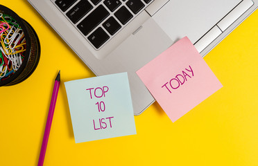 Text sign showing Top 10 List. Business photo text the ten most important or successful items in a particular list Trendy metallic laptop sticky notes clips container pencil colored background