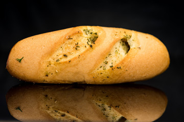 Tea bun on a black background. Photographed close up.
