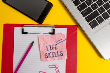 Word writing text Life Skills. Business photo showcasing skill that is necessary for full participation in everyday life Laptop clipboard sheet clips pencil note smartphone colored background