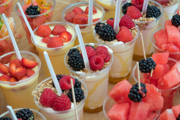  Plastic glasses with different fruit and drinks