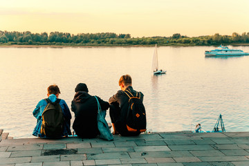 Teenagers sitting on the river Bank