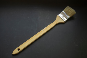 big brush for paint wall, wood tool, item for work, black background