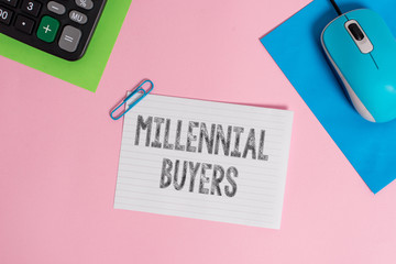 Conceptual hand writing showing Millennial Buyers. Concept meaning Type of consumers that are interested in trending products Wire electronic mouse calculator paper colored background