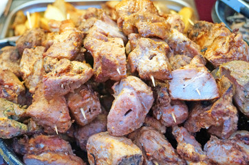 Juicy and tasty kebabs fried on a brazier on a picnic on a sunny day