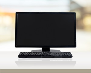 Desktop computer and keyboard on background