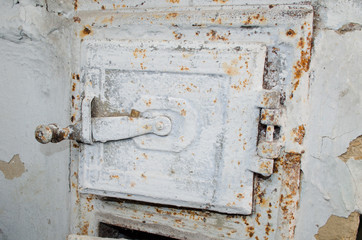 Traditional old metal oven door with rust