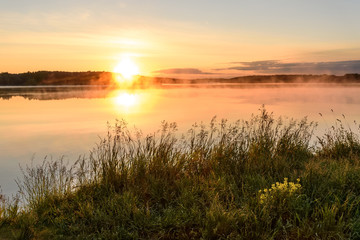 Fototapeta na wymiar lake sunrise sun fog grass