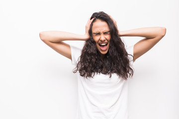 Fototapeta premium Portrait of a frustrated angry woman screaming out loud and pulling her hair out isolated on the white background