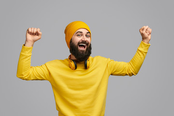 Naklejka premium Excited hipster dancing with clenched fists