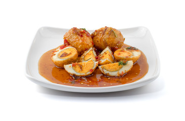 Egg with Tamarind Sauce (Kai Look Keuy or Son-in-Law Eggs) isolated on the white background