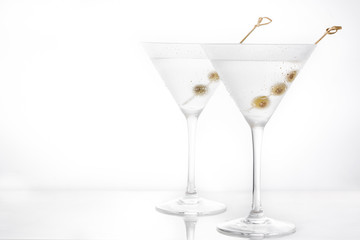Classic Dry Martini with olives isolated on white background. Copyspace