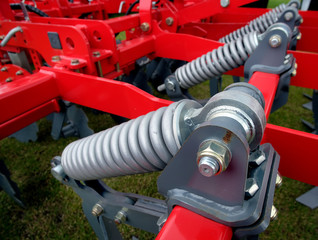 Large coil springs on modern farmng equipment.