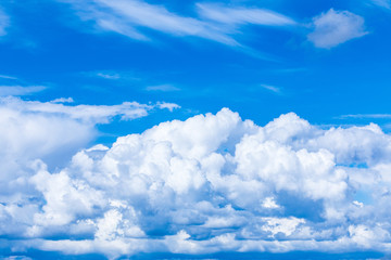 The vivid sky or heaven background with white and blue clouds under the sun rays