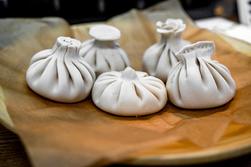 Khinkali, Georgian dumplings, traditional Georgian cuisine. Khinkali on a plate side view.