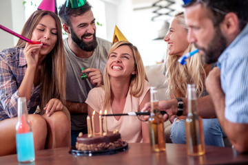 Happy young woman celebrating birthday at home