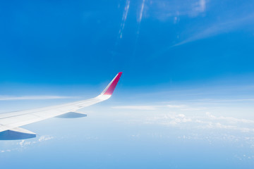 Naklejka na ściany i meble aircraft Wing on cloudscape and blue sky