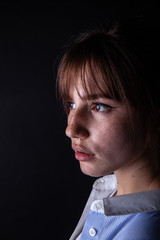 Close-up shot of a young caucasian girl face with freckles