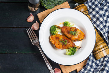 Chicken Legs with Vegetables on wooden table.