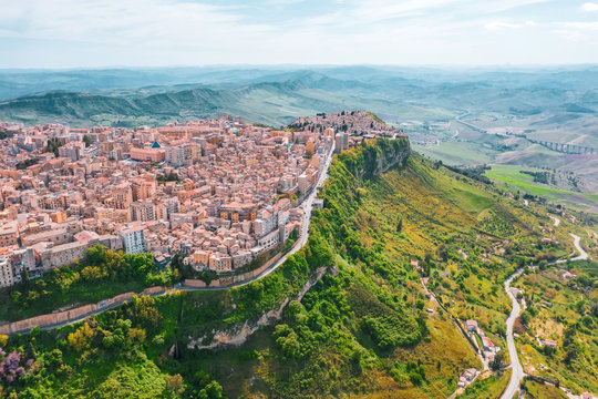 The town of Enna Italy Sicily on a hillside cliff, aerial view.