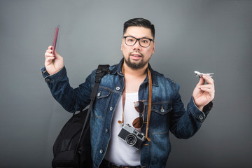 A mature man carries his schoolbag and equipment to travel.