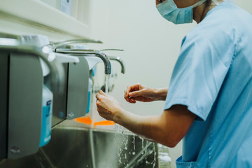Unrecognizable doctor washing hands before operating