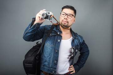 A mature man carries his schoolbag and equipment to travel.