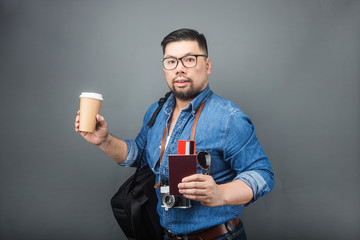 A mature man carries his schoolbag and equipment to travel.