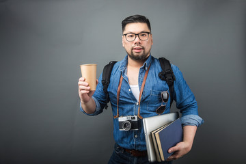 A mature man carries his schoolbag and equipment to travel.