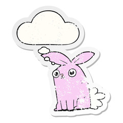 cartoon bunny rabbit and thought bubble as a distressed worn sticker