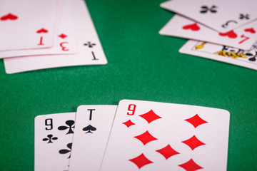 playing cards on a green table in different combinations close-up