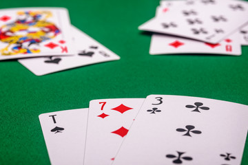 playing cards on a green table in different combinations close-up