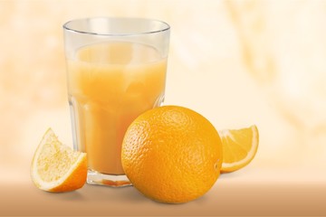 Orange juice and slices of orange on background
