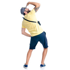 Man in shorts and cap standing looking on white background isolation, back view