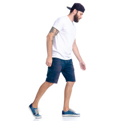 Man in shorts and cap standing goes walking running on white background isolation