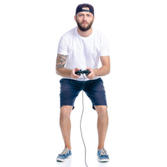 Man in shorts and cap with gamepad in hand on white background isolation © Kabardins photo
