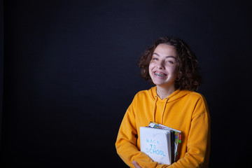 Young caucasian girl holding notebook with Back to School