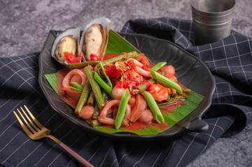 pink spicy seafood noodle Fried noodle with sea food and kale in gravy , Thai Food