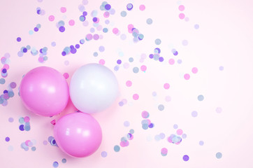 Bright background with small confetti and balloons.