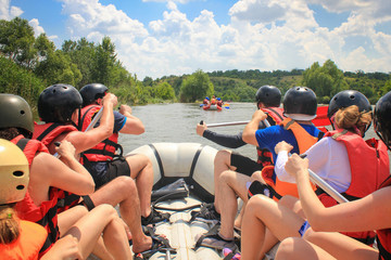 Rafting team , summer extreme water sport.  Group of people in a rafting boat, beautiful adrenaline...