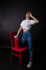 Young caucasian lady posing with fire extinguisher in hand